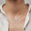 Load image into Gallery viewer, Model wearing a silver angel wing necklace 
