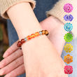 Load image into Gallery viewer, Model wearing chakra bracelet on her hand

