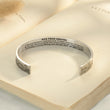Load image into Gallery viewer, Hug From Heaven Wide Cuff Memorial Bracelet on top of an open book
