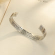 Load image into Gallery viewer, Hug From Heaven Wide Cuff Memorial Bracelet on top of an open book
