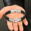 Load image into Gallery viewer, Male model holding a Braided Leather Bracelet
