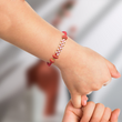 Load image into Gallery viewer, Red Knot Bracelet worn by a child
