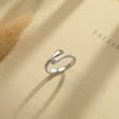Load image into Gallery viewer, silver Hug From Heaven Memorial Ring on a book page
