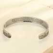 Load image into Gallery viewer, Brazalete Eres Mi Luz de Sol encima de un libro abierto
