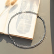 Load image into Gallery viewer, Silver link chain necklace on top of a book
