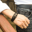 Load image into Gallery viewer, Black cross variant of Hug From Heaven Leather Cross Bracelet on male model
