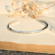 Load image into Gallery viewer, To My Son Personalized Minimalist Cuff silver Bracelet placed on the top of abook
