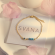 Load image into Gallery viewer, Beaded Blue Evil Eye Gold Chain Ankle Bracelet on top of a SVANA Design card
