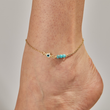 Load image into Gallery viewer, A model wearing Evil Eye Gold Chain Ankle Bracelet
