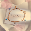 Load image into Gallery viewer, Blue Star Evil Eye Gold Chain Ankle Bracelet on top of a SVANA Design card
