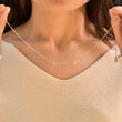 Load image into Gallery viewer, Woman holding a rose gold necklace with initials
