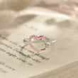 Load image into Gallery viewer, And So She Goes On Semicolon Heart Adjustable Ring on page of an open book
