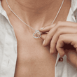 Load image into Gallery viewer, Cardinal Heart Memorial Necklace worn by a model while holding the pendant 
