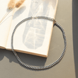 Load image into Gallery viewer, To My Son, Be Confident Chain Silver Necklace isolated on the top of a book 
