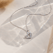 Load image into Gallery viewer, To My Daughter, Our Hearts Are Always Linked Together Interlocking Heart Necklace on a beige background
