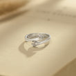 Load image into Gallery viewer, Silver Personalized Hug Ring placed at the top of a book
