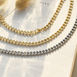 Load image into Gallery viewer, silver and gold Link Chain Necklaces on an open book page
