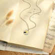 Load image into Gallery viewer, Wanderlust Mountain Necklace on top of a book page

