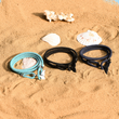 Load image into Gallery viewer, Three bracelets next to each other on a beach sand with shells around
