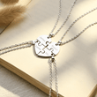 Load image into Gallery viewer, Family Gift Personalized Heart Puzzle Piece Necklace placed at the edge of a book
