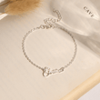 Load image into Gallery viewer, To My Granddaughter Custom Name Ankle silver  Bracelet placed on the top of a book
