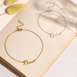 Load image into Gallery viewer, To My Granddaughter Custom Name Ankle Bracelet placed on the top of an open book
