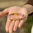 Load image into Gallery viewer, model showing Blossom Knot Bracelet on her open palms
