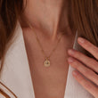 Load image into Gallery viewer, Jeweled Blue Star of David Gold Coin Necklace worn on the neck by a female model
