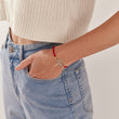 Load image into Gallery viewer, a model wearing Turquoise Tree of Life Red String Bracelet on her left wrist
