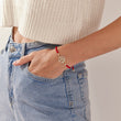 Load image into Gallery viewer, Round Tree of Life Red String Bracelet worn by a model on her left wrist
