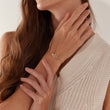 Load image into Gallery viewer, A model wearing Multicolored Stone Hamsa Hand Gold Chain Bracelet on her right wrist
