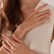 Load image into Gallery viewer, Jeweled Cross Bracelet worn by a model on her left wrist
