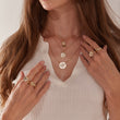 Load image into Gallery viewer, three Jeweled Sunflower Gold Necklace worn on the neck and four Jeweled Sunflower Gold rings worn on different fingers by a female model
