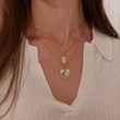 Load image into Gallery viewer, Jeweled Moon Gold Tag Necklace worn by a model together with other necklaces
