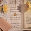 Load image into Gallery viewer, Round Medallion Hamsa Hand Necklace on top of music sheets
