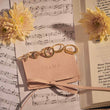 Load image into Gallery viewer, White Stone Crescent Moon Adjustable Ring with four other rings on top of a music sheet
