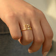 Load image into Gallery viewer, A model wearing a 777 Angel Number Gold ring
