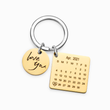 Load image into Gallery viewer, Personalized calendar gold keychain on a white background
