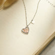 Load image into Gallery viewer, To My Mommy - Baby Feet Heart Pendant Necklace placed on the top of an open book page
