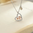 Load image into Gallery viewer, To My Mommy - Baby Feet Heart Pendant Necklace hanging on the top of a book
