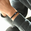 Load image into Gallery viewer, To My Grandson Evil Eye Braided Bracelet worn by a model on his left wrist
