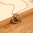 Load image into Gallery viewer, Cardinal Heart Memorial Necklace leaning on an open book
