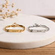 Load image into Gallery viewer, gold and silver Personalized Baby Name Bracelets on a ceramic coaster
