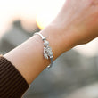 Load image into Gallery viewer, To My Daughter Dreamcatcher Bangle worn by a female model on her left wrist
