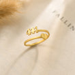 Load image into Gallery viewer, 444 Angel number gold ring placed on top of a piece of paper

