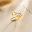 Load image into Gallery viewer, 666 Angel number gold ring placed on top of a piece of paper
