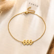 Load image into Gallery viewer, Angel number 666 gold anklet placed on top of a book
