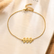 Load image into Gallery viewer, 999 Angel number gold anklet placed on top of a piece of paper
