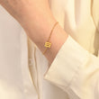 Load image into Gallery viewer, A model wearing an Angel Number 111 Bracelet on her left wrist
