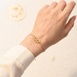 Load image into Gallery viewer, A model wearing an Angel Number 222 Bracelet on her left wrist
